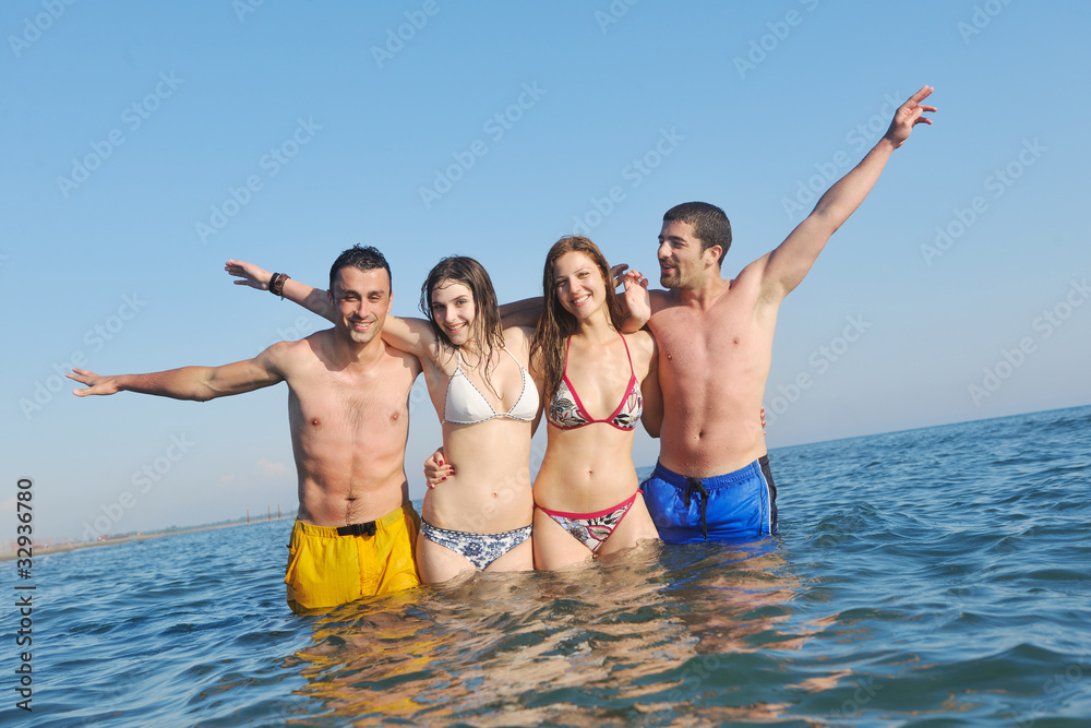 happy young  people group have fun on beach