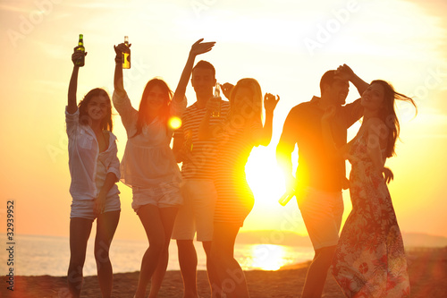 Group of young people enjoy summer  party at the beach photo