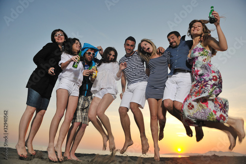 Group of young people enjoy summer  party at the beach