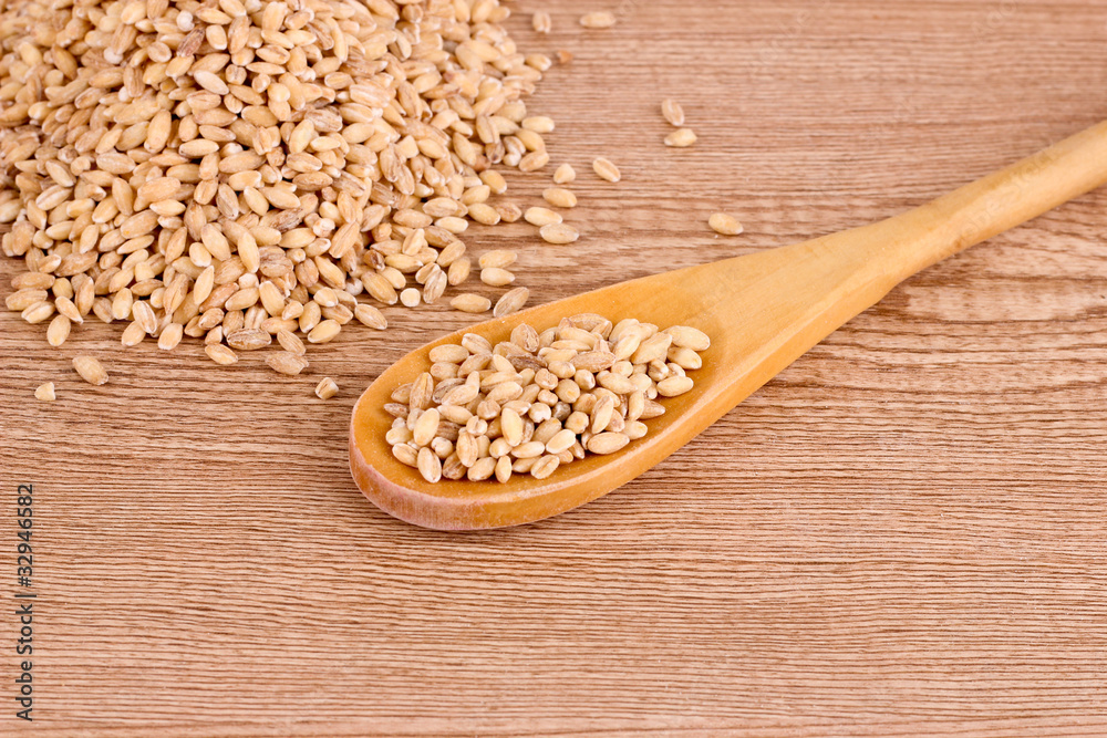 wheat and spoon on brown wheat and spoon on brown