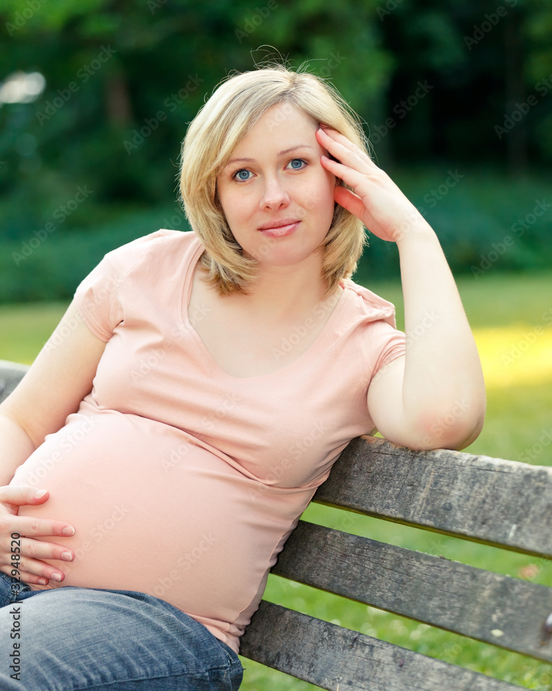 Pregnant woman resting in the park Pregnant woman resting in the park
