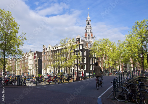 Sticker Amsterdam. man rides a bicycle across the bridge.