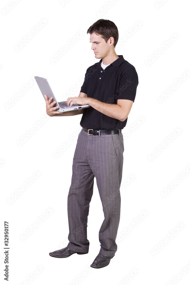 Young man standing and working  on laptop