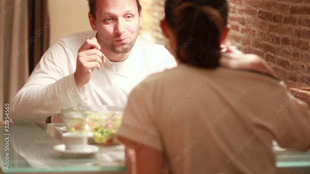 Couple eating dinner, focus on man Couple eating dinner, focus on man