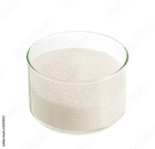 White sugar in round glass bowl