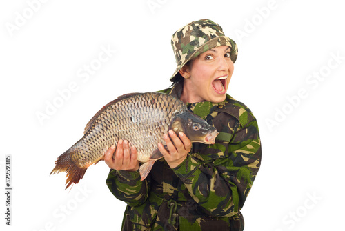 Amazed fisher woman holding big carp photo