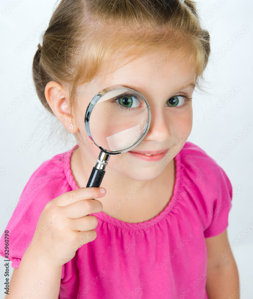 little girl looking through a magnifying glass little girl looking through a magnifying glass
