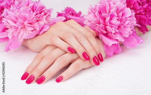 Manicure with pink fingernails and peony flowers