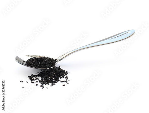 Black tea in a metal spoon