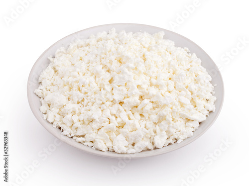 Cottage cheese in plate isolated on white background