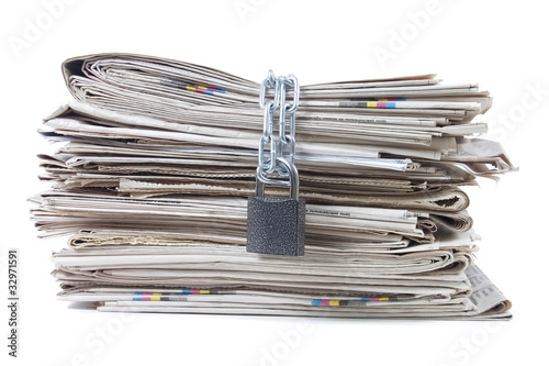 pile of newspapers with chains photo