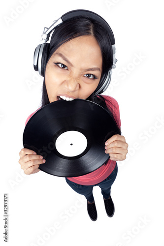 Female Asian DJ biting a record