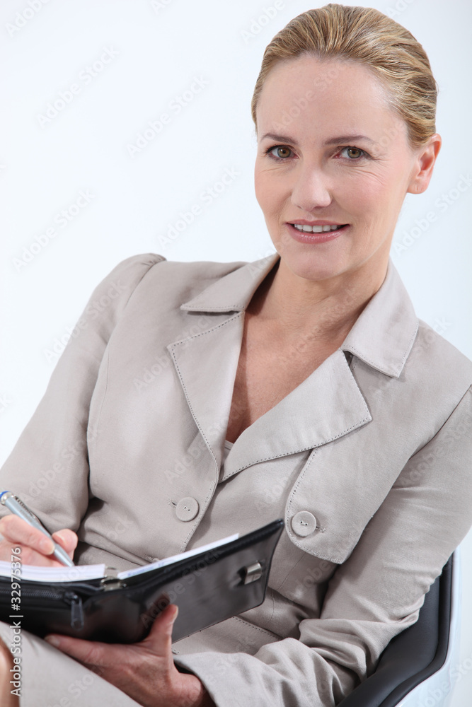 Professional blonde woman with a personal organizer Professional blonde woman with a personal organizer