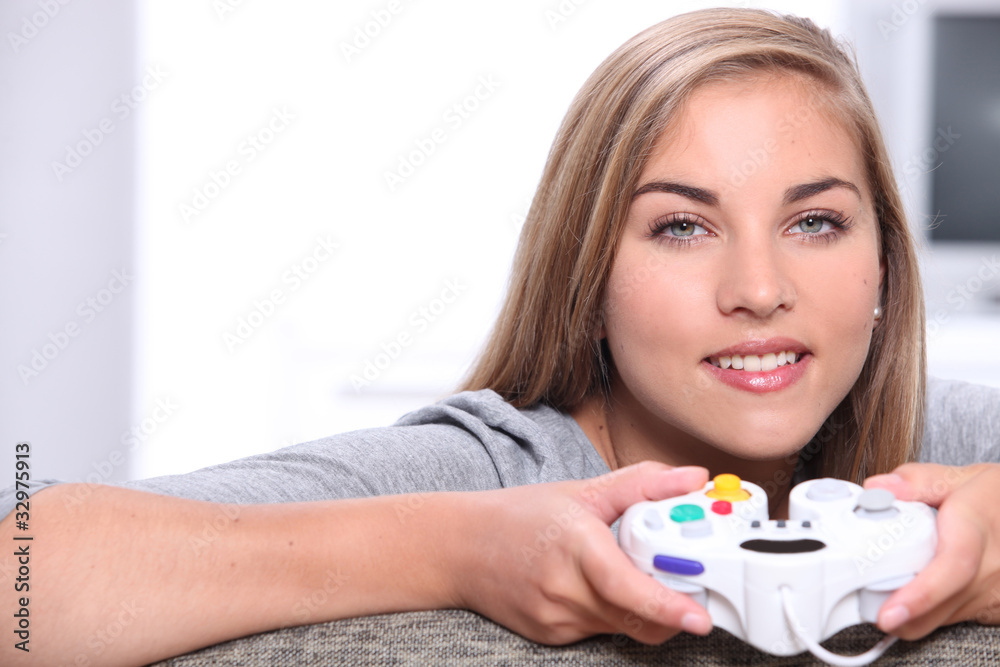 blonde girl playing video games with a control pad blonde girl playing video games with a control pad