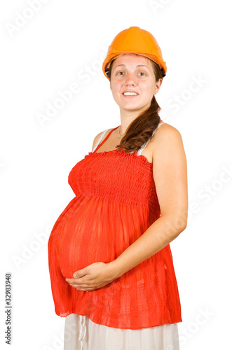 woman in hardhat holding pregnant belly photo