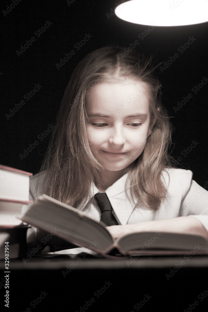 Girl reading book under lamp Girl reading book under lamp