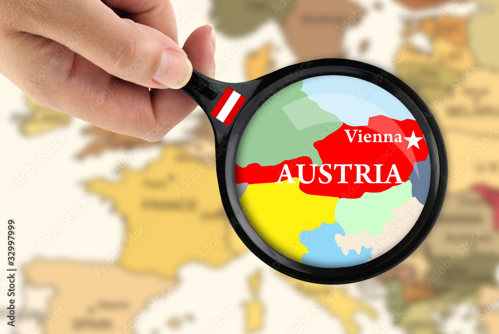 Naklejka premium Magnifying glass over a map of Austria