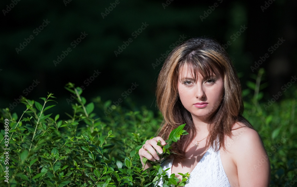 ung beautiful girl sits on green lawn and smiles. ung beautiful girl sits on green lawn and smiles.