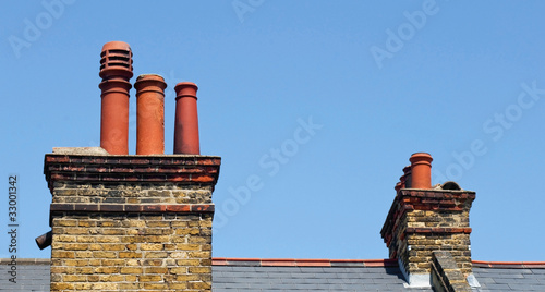 Chimney stacks on the roof of a victorian terrace house photo