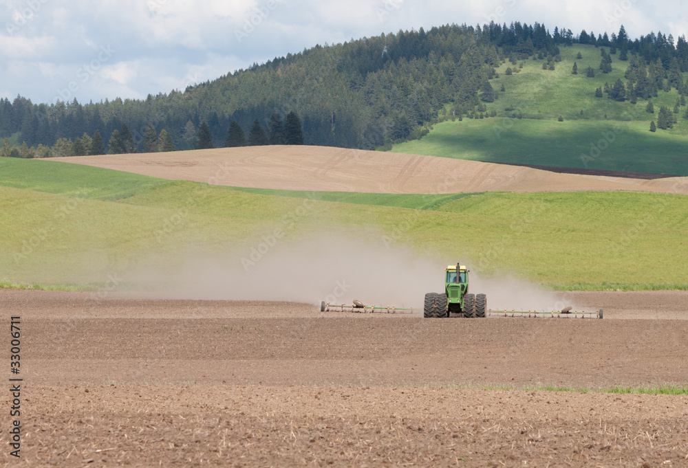 Obraz premium Tractor plowing the fields