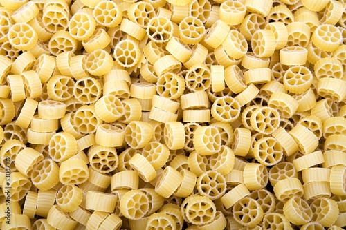 Raw Wagon wheel pasta noodles closeup macro photo