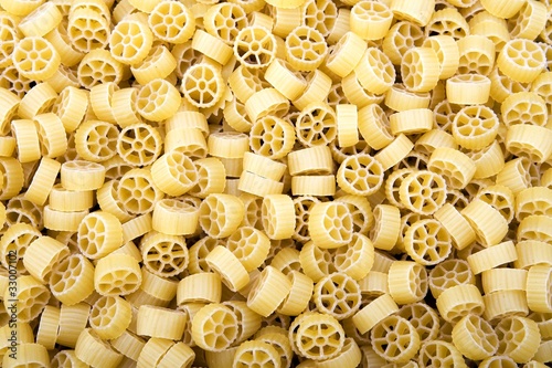 Raw Wagon wheel pasta noodles closeup macro