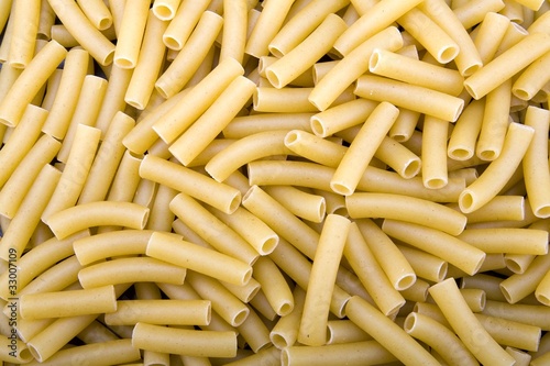 Raw ziti pasta noodles closeup macro