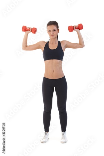 Sexy woman exercising with dumbbells