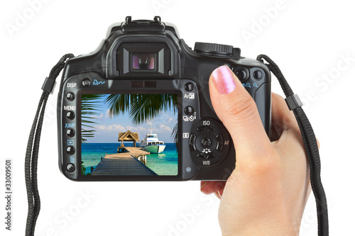 Camera in hand and beach landscape