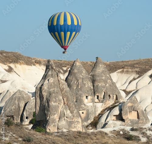 Balloon Over Rock Cave Houses, Cappadocia photo