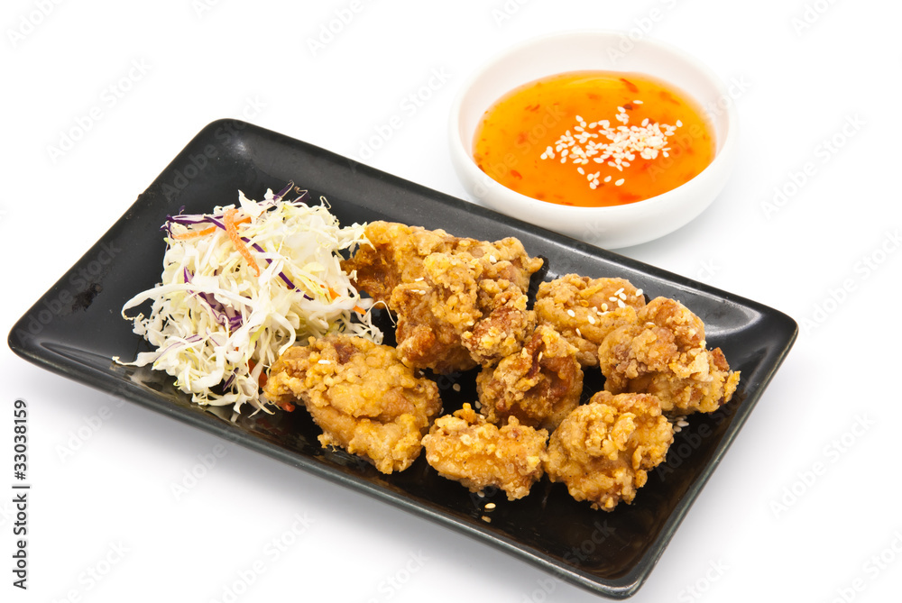 fried chicken in black plate with sauce