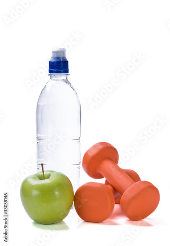 Bottle of water with fitness weights and apple