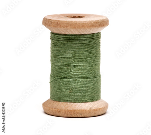 Thread bobbin on white background photo