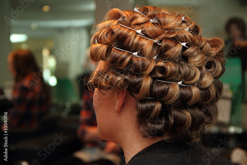 Hair in curlers at the hairdresser. A bride preparing.