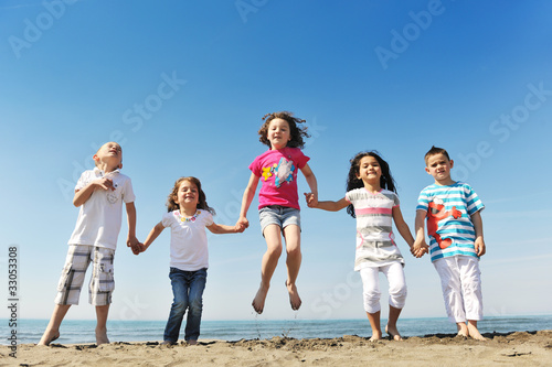 happy child group playing on beach