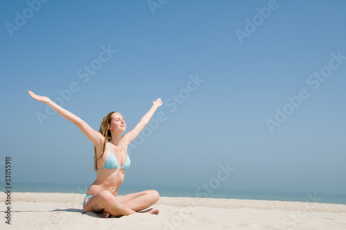 Young girl enjoying the sun on the beach