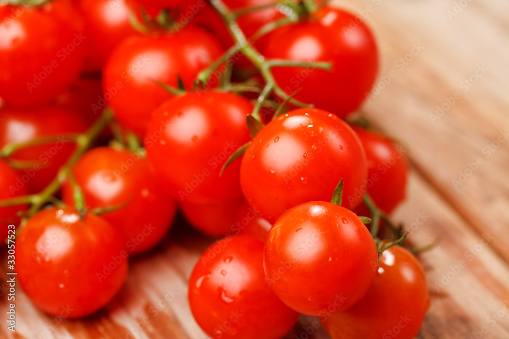 Cherry tomatoes on the wood background Cherry tomatoes on the wood background