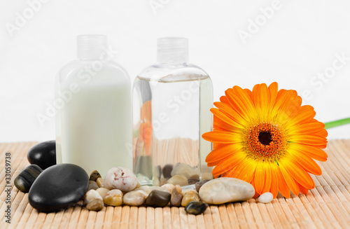 Sunflower with  round smooth pebbles and glass bottles