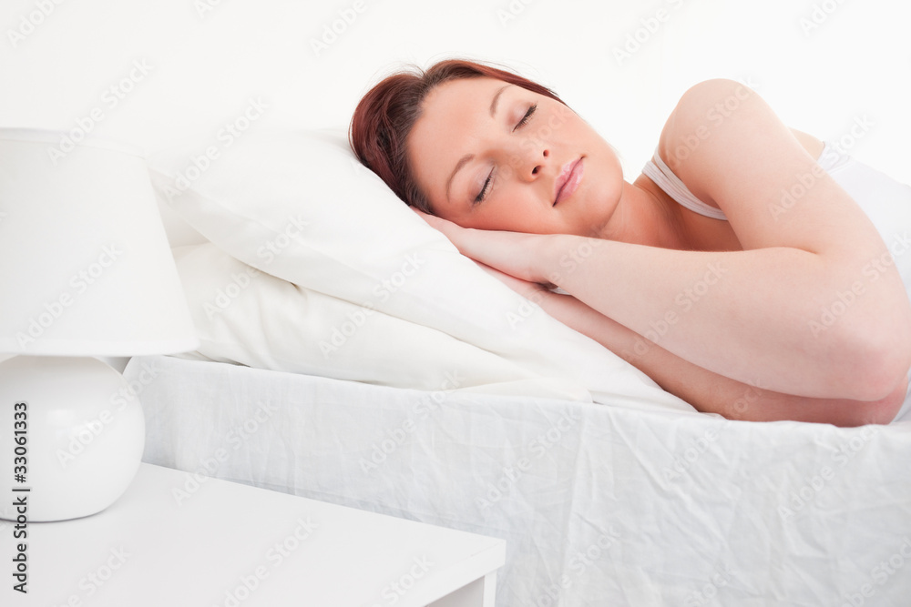Beautiful red-haired female sleeping in her bed Beautiful red-haired female sleeping in her bed