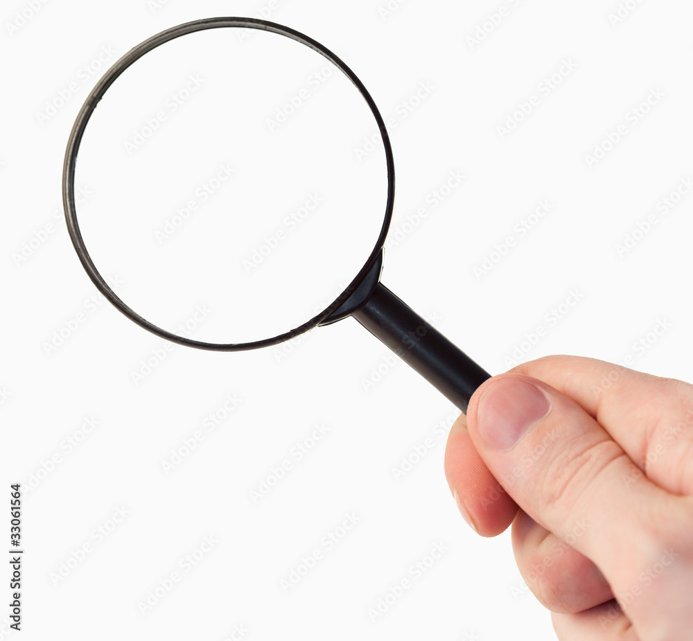 Hand holding a magnifying glass