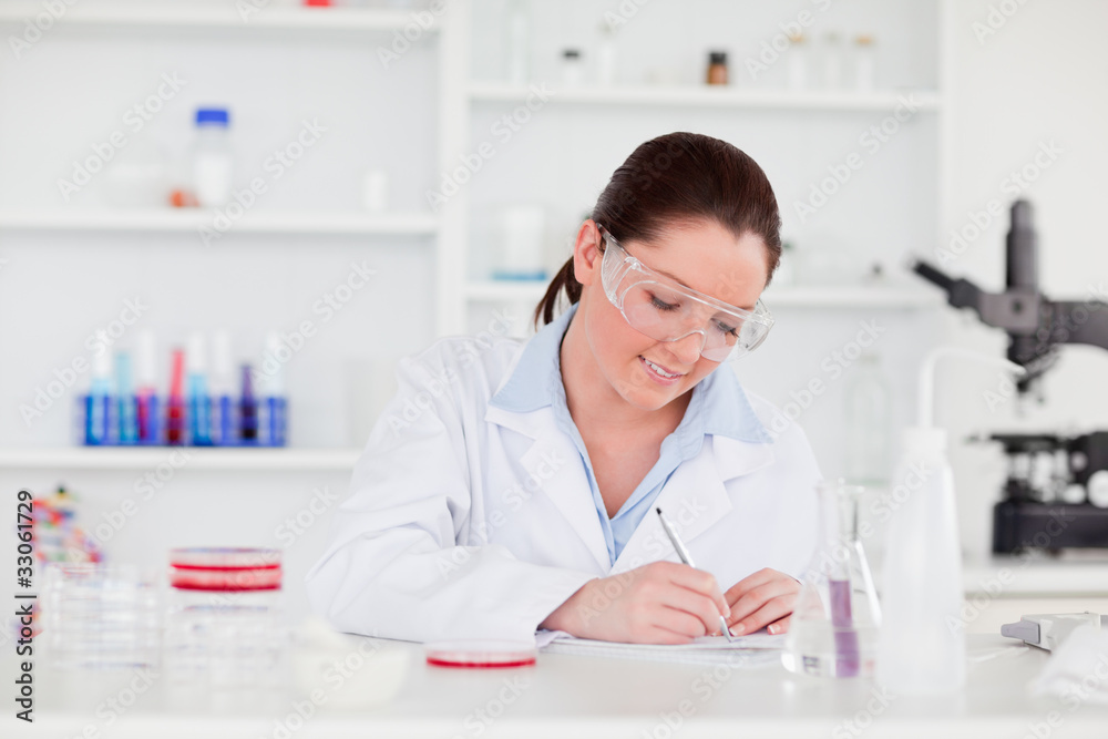 Young scientist writting a report Young scientist writting a report