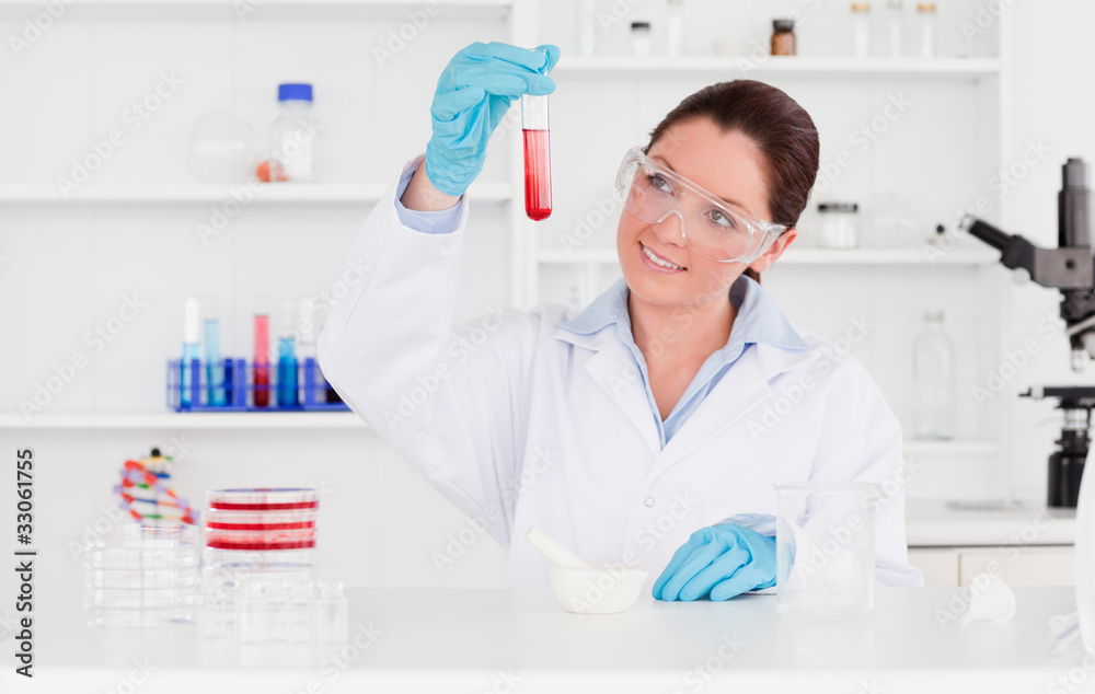 Young scientist looking at a test tube Young scientist looking at a test tube