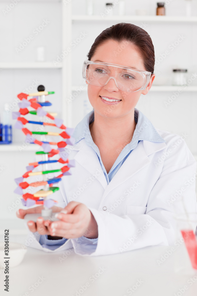 Cute scientist showing the dna double helix model Cute scientist showing the dna double helix model