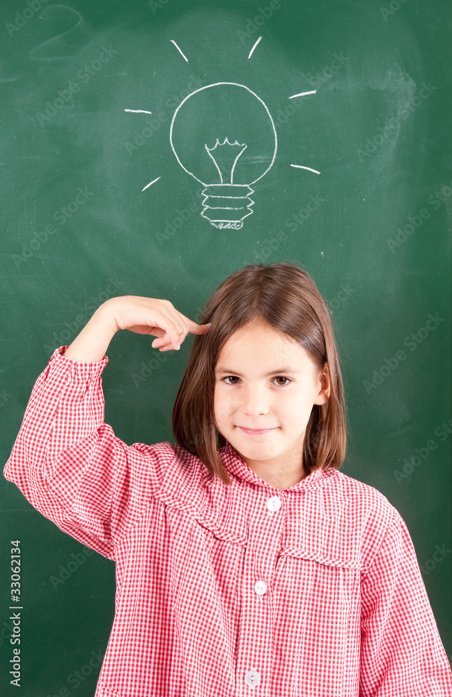little girl with blackboard and lightbulb over her head