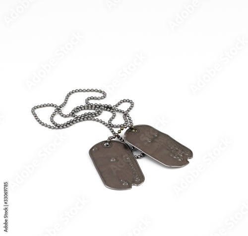 Old metal military dog tags on a pure white background photo