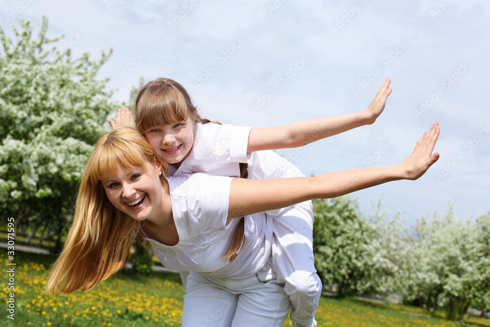 Fototapeta premium girl with mother in spring park
