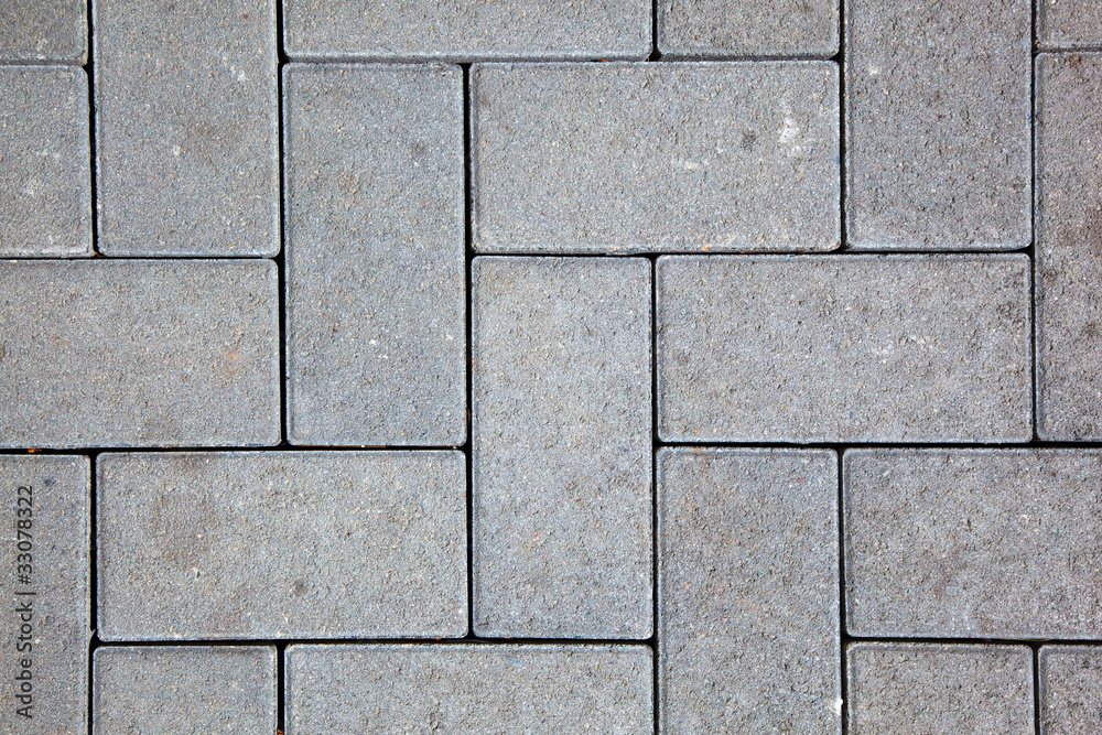 Fototapeta premium pavement pattern made with cast concrete blocks in grey color