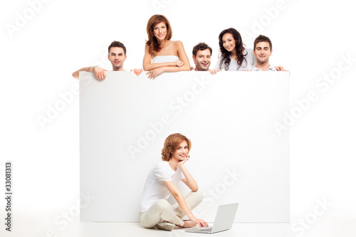 friends behind white board and laptop