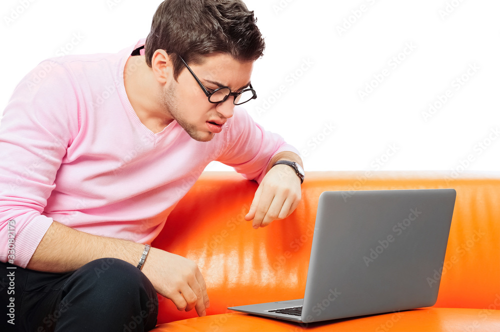 Closeup portrait of young man using laptop Closeup portrait of young man using laptop