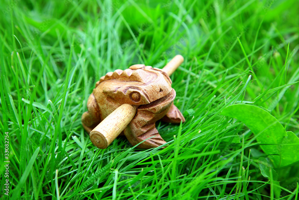 Asian handmade wealthy frog on green grass background Asian handmade wealthy frog on green grass background